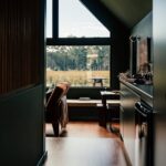 Serene modern interior featuring a large window with a scenic view of nature.