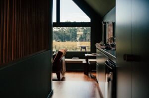 Serene modern interior featuring a large window with a scenic view of nature.